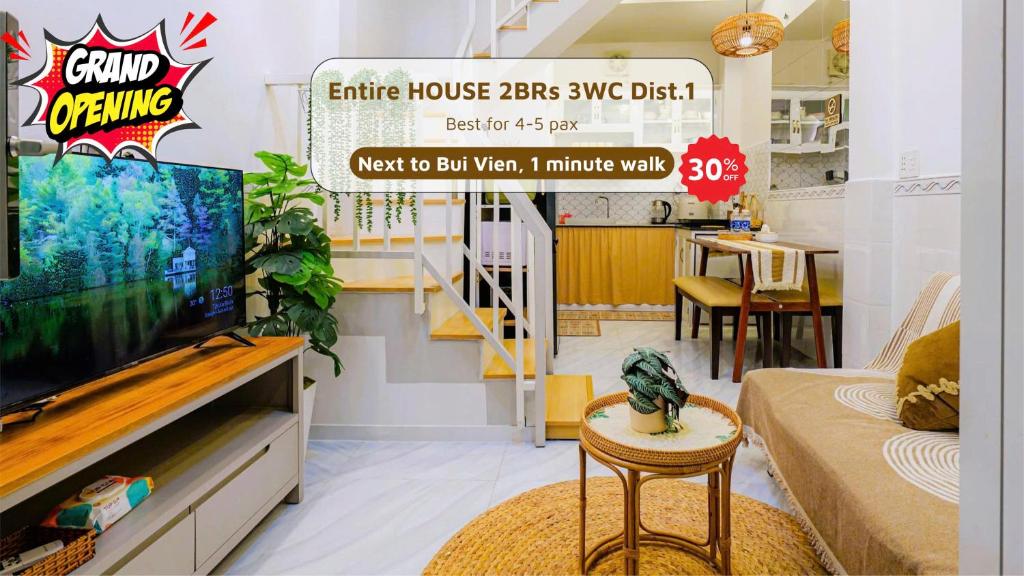 a living room with a tv and a couch and a table at LoCo's FullHouse - SAIGON CENTRE - D1 in Ho Chi Minh City