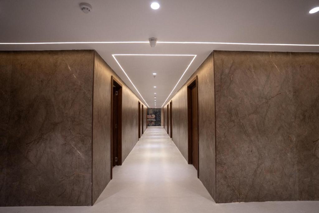 a hallway of a building with brown walls and a long corridor at Ricch Hotels in Hyderabad