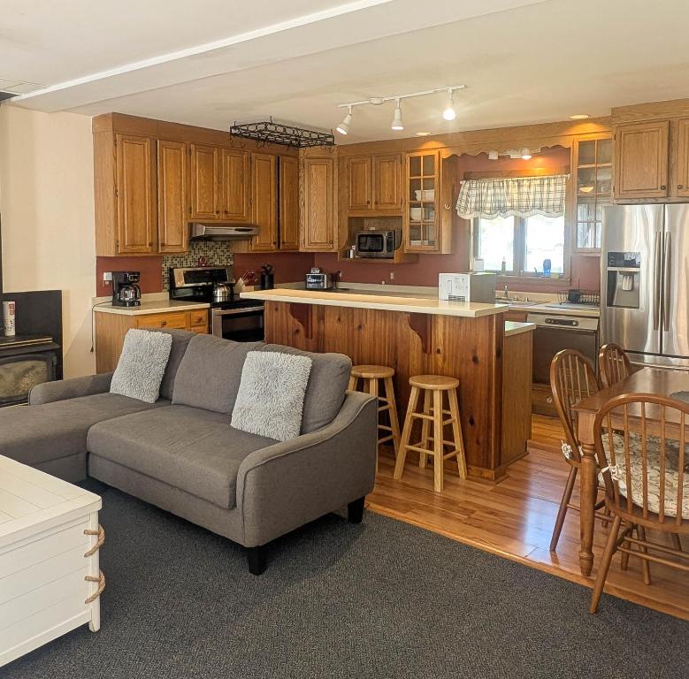a living room with a couch and a kitchen at 3 Bedroom 2 Bath Carriage House (Pet Friendly) in Bar Harbor