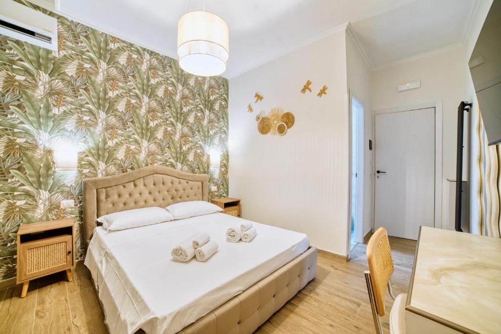 a bedroom with a bed with towels on it at Radio Suites in Rome