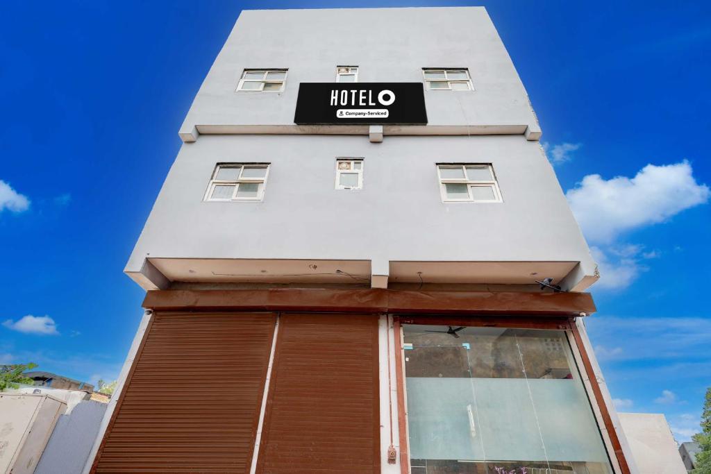 a white building with a sign on it at Townhouse Sector 33 Gurgaon in Gurgaon