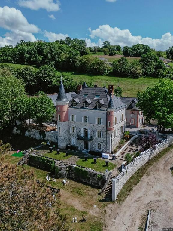 an aerial view of a large house with a fence at Château de Saint-Genix in Saint-Genix-sur-Guiers