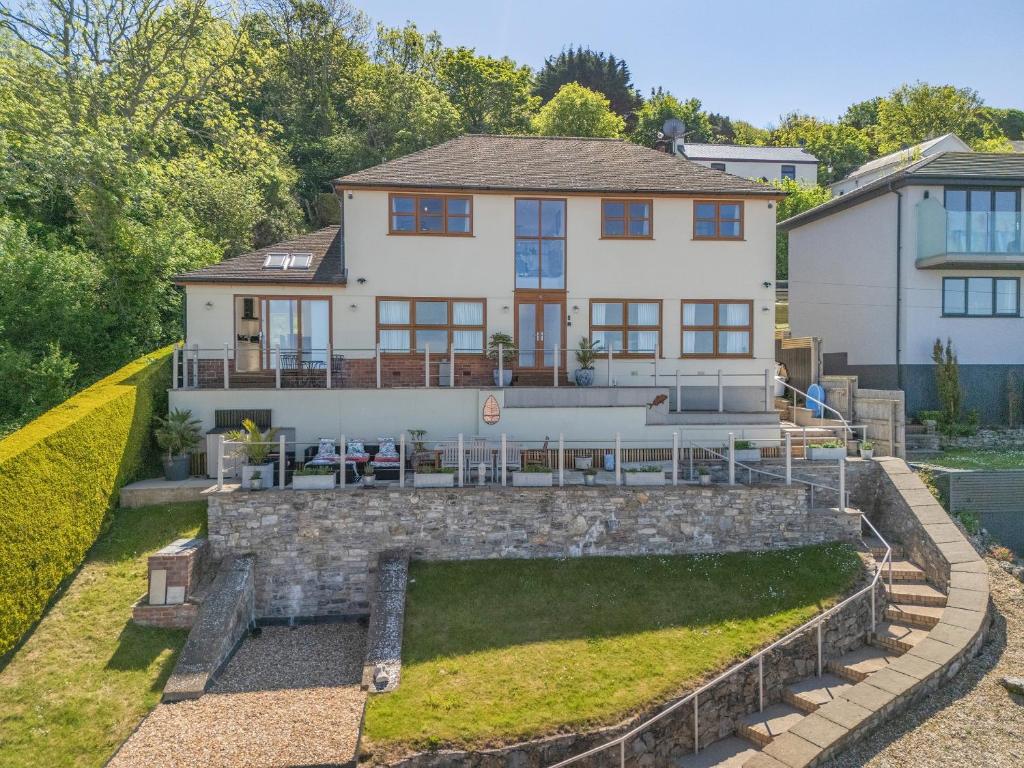 an aerial view of a house with a stone wall at Baobab Lodge in Prestatyn