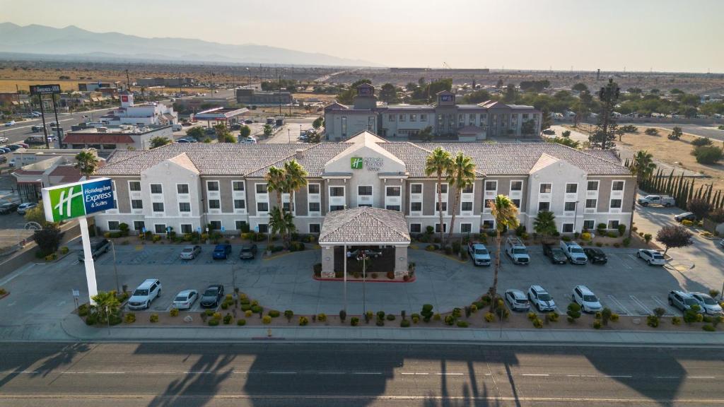 an aerial view of a hotel with a parking lot at Holiday Inn Express Hotel & Suites Hesperia by IHG in Hesperia