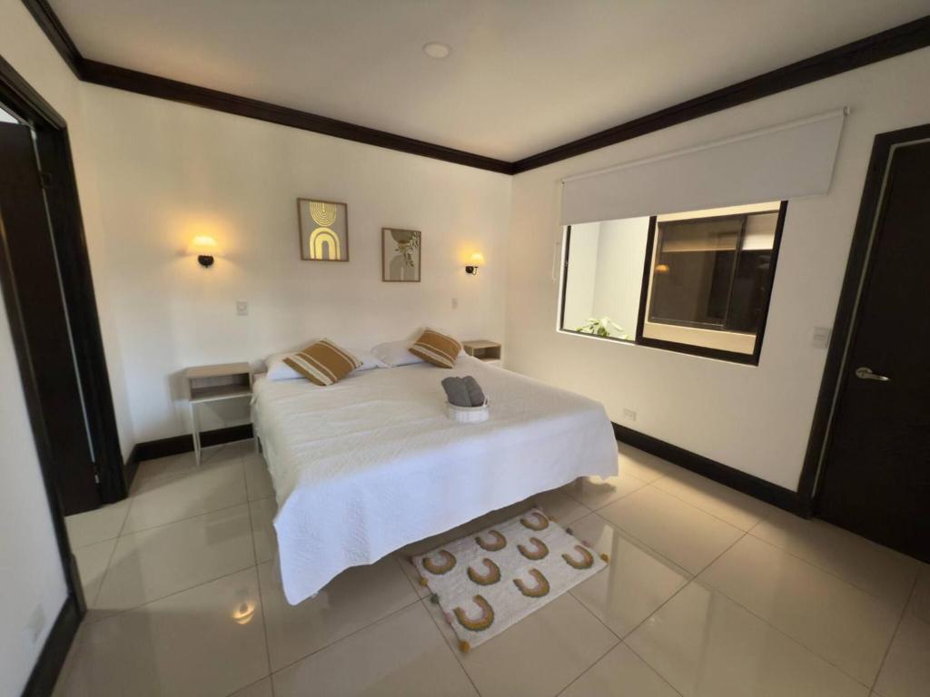 a bedroom with a bed and a window at Fully Equipped 3 beds 2 cars 20-min airport in La Puebla