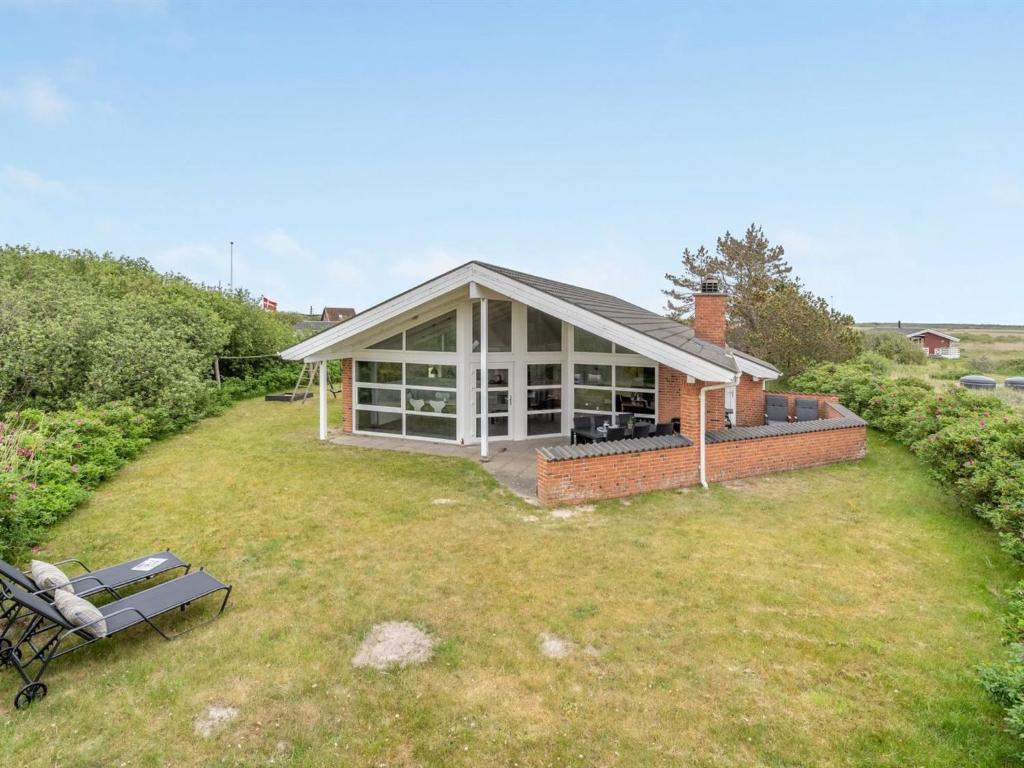 a house with a lawn in front of it at Holiday Home Solina - 500m from the sea by Interhome in Lakolk