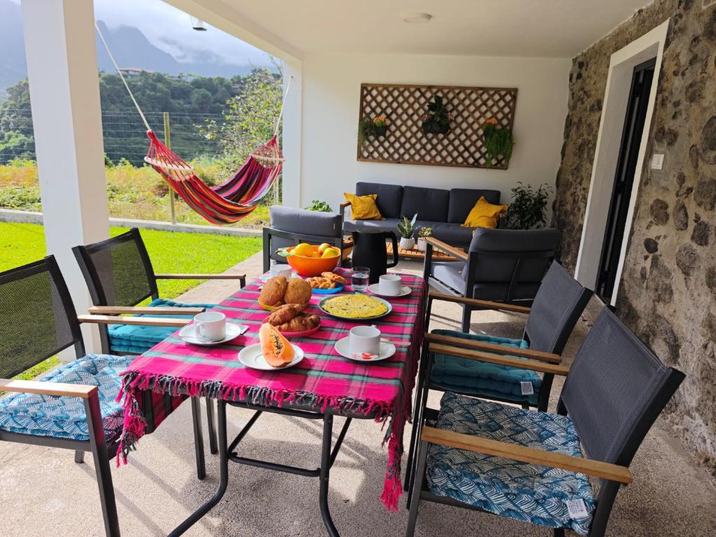 a dining room with a table and chairs at CASA GIRASSOL " uma Janela para o Nascer do Sol " in São Vicente