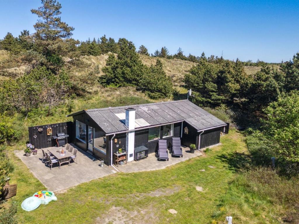 an overhead view of a black house on a hill at Holiday Home Inga - 1-3km from the sea by Interhome in Mølby