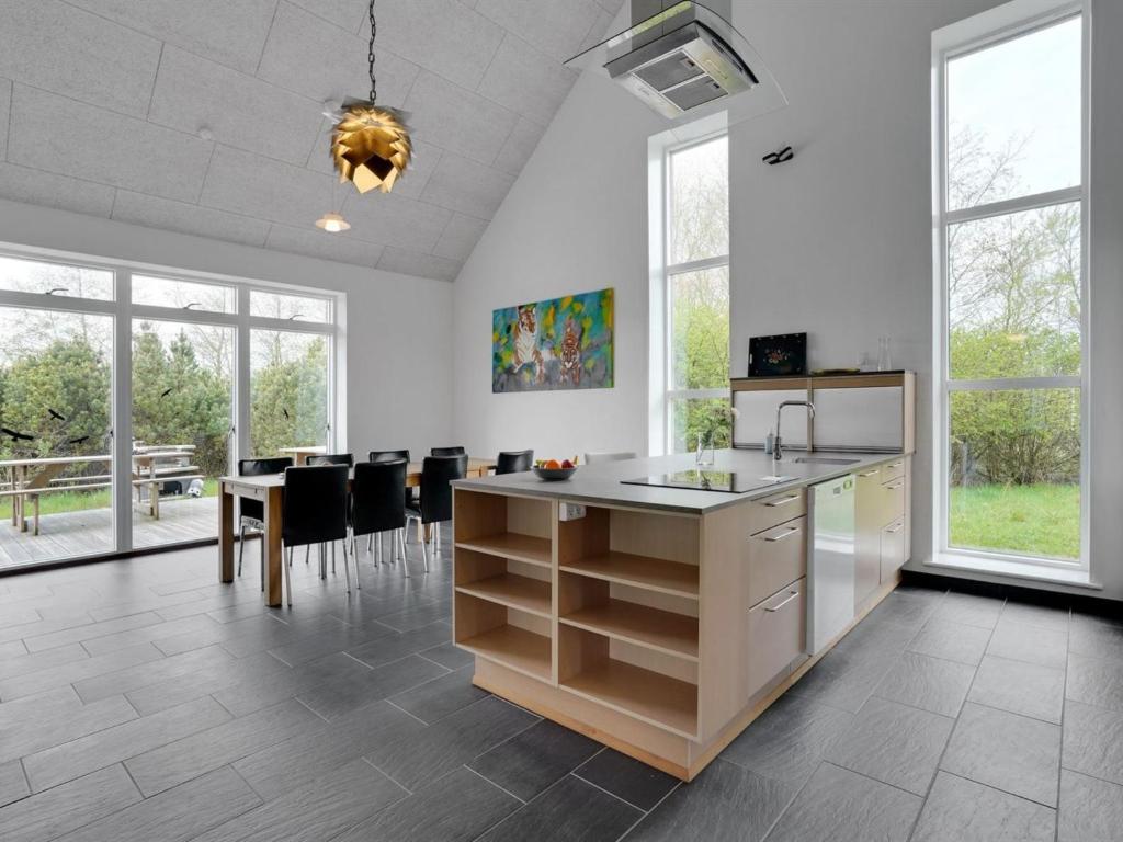 a kitchen with white walls and a table and chairs at Holiday Home Henrieta - 4km from the sea by Interhome in Toftum