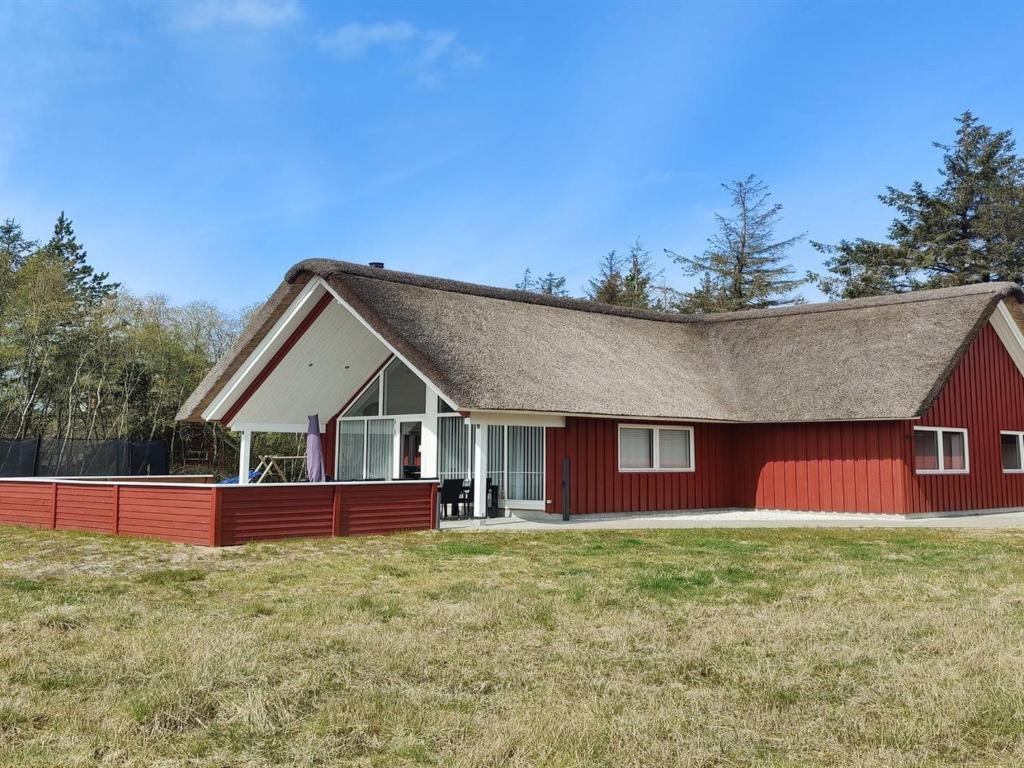 a red barn with a red roof at Holiday Home Lima - 3-5km from the sea by Interhome in Kongsmark