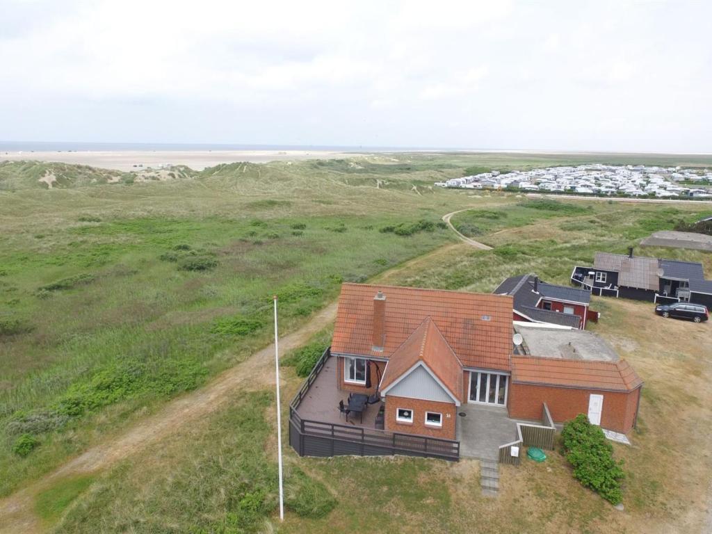 an aerial view of a house in a field with the ocean at Holiday Home Helfrida - 350m from the sea by Interhome in Lakolk