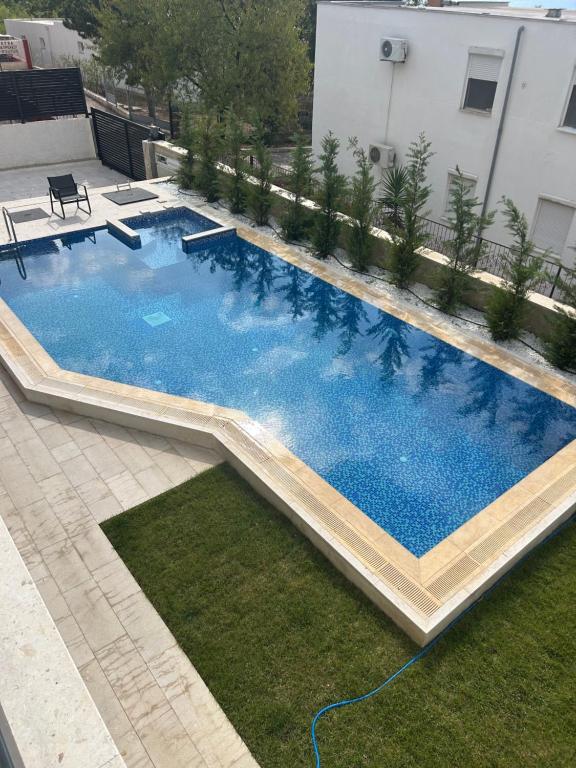 a large swimming pool sitting on top of a yard at Villa Richard in Sutomore