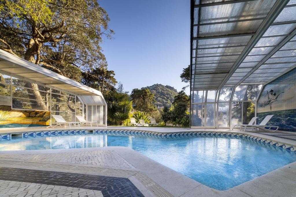 a swimming pool in front of a building at Sintra Marmoris Palace in Sintra