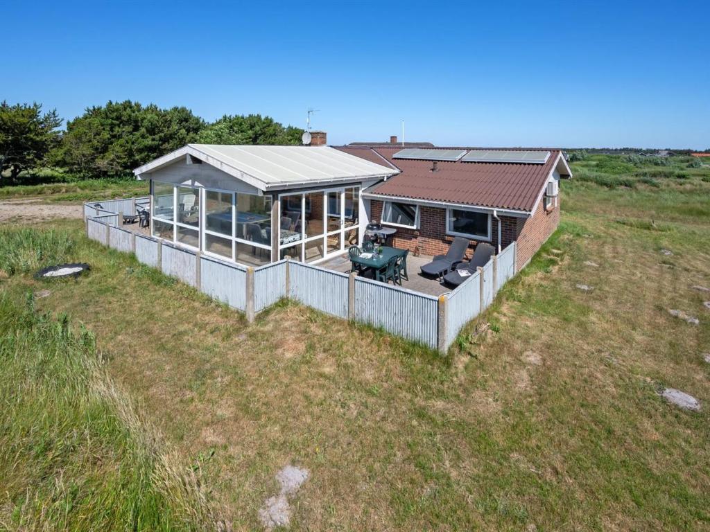 an aerial view of a house in a field at Holiday Home Nanette - 300m to the inlet by Interhome in Ringkøbing