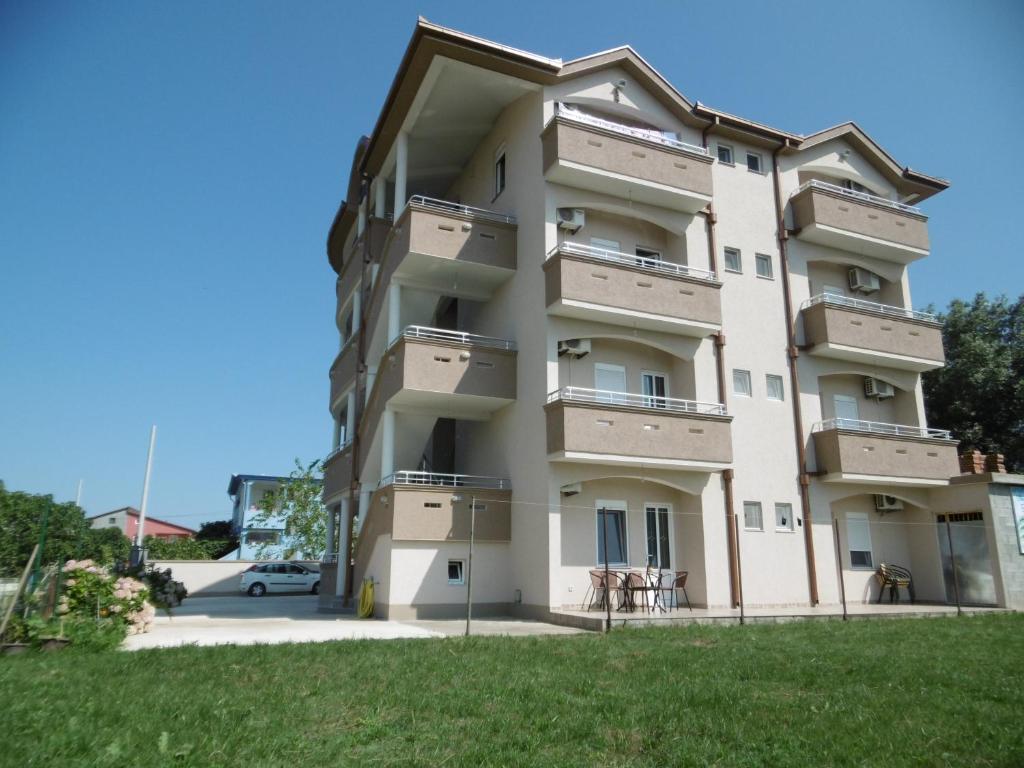 a building with balconies on the side of it at Apartments Dukat in Ulcinj