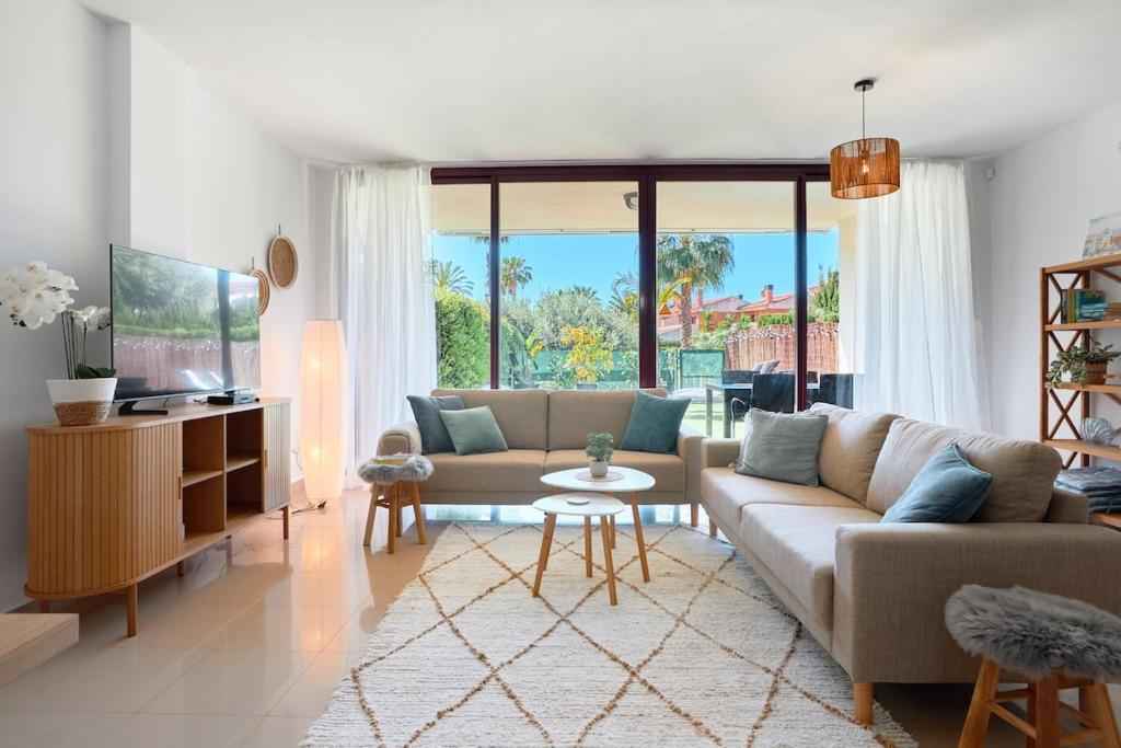 a living room with a couch and a table at Charming Bungalow in Venta Lanuza - by Welcomely in El Campello