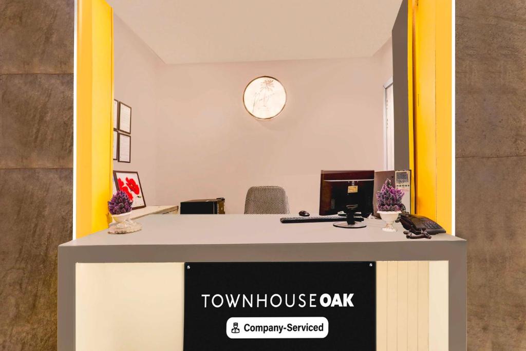 an office with a desk with a town house oak sign at Townhouse Oak Vaishali Nagar Jaipur in Jaipur