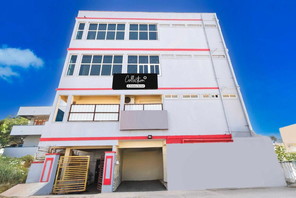 a white building with a black sign on it at Collection O Chengicherla Hyderabad in Hyderabad