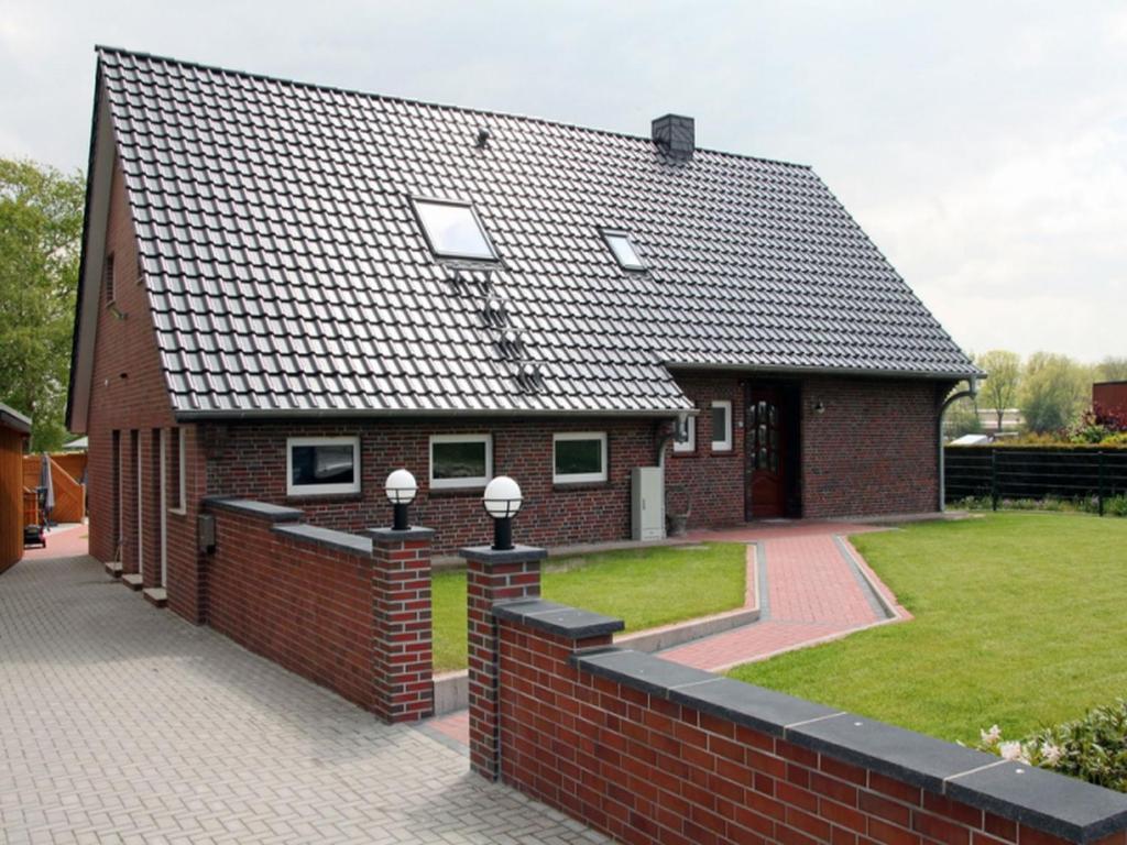 a red brick house with a black roof at Haus Hermann in Mederns