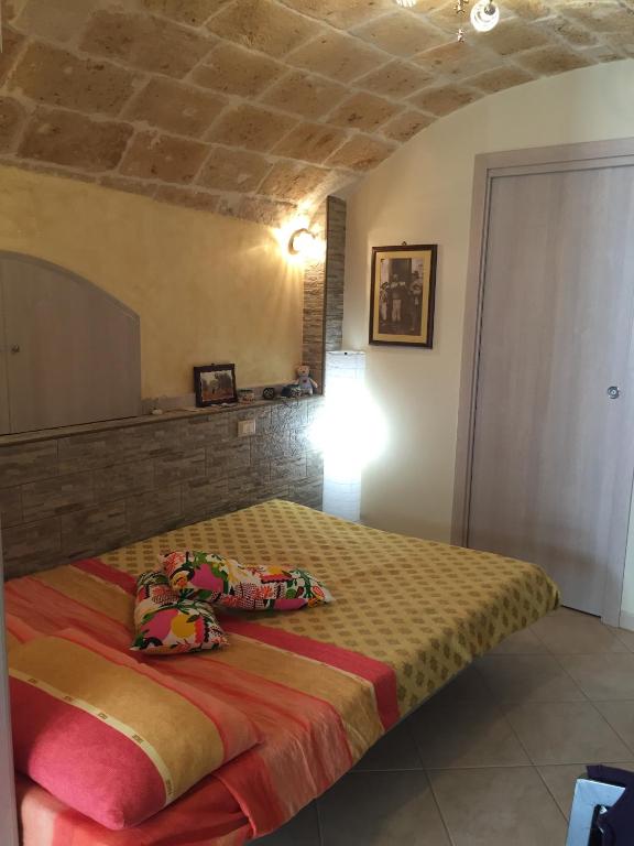 a bedroom with a bed with pillows on it at Sea Home 1 in Monopoli