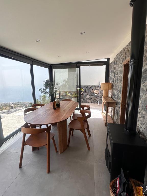 a living room with a wooden table and a fireplace at Casa Arriettas in Tijarafe
