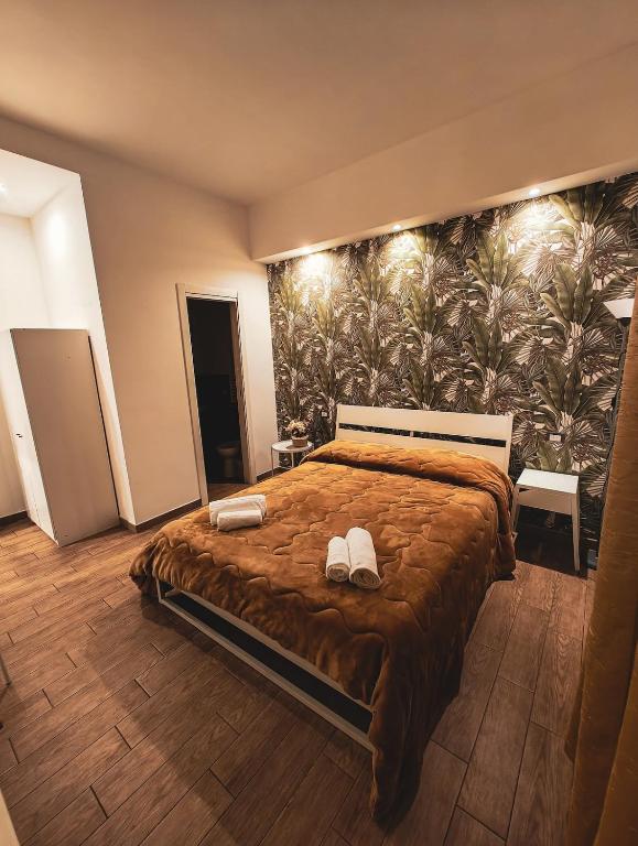 a bedroom with a large bed with shoes on it at MVM Apartment in Rome