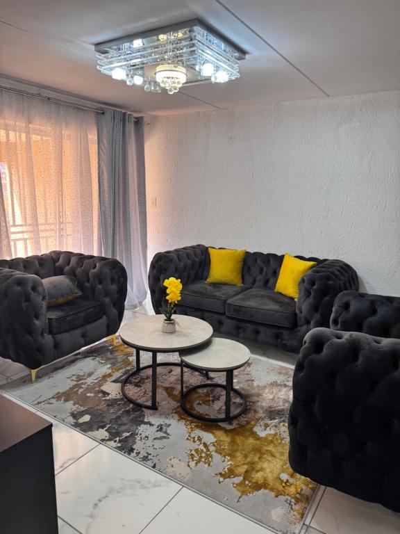 a living room with two couches and a table at Luxe spot in Johannesburg