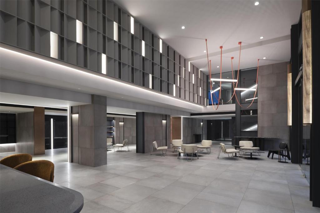 The main lobby with high ceilings, lounge seating and a dramatic light installation.