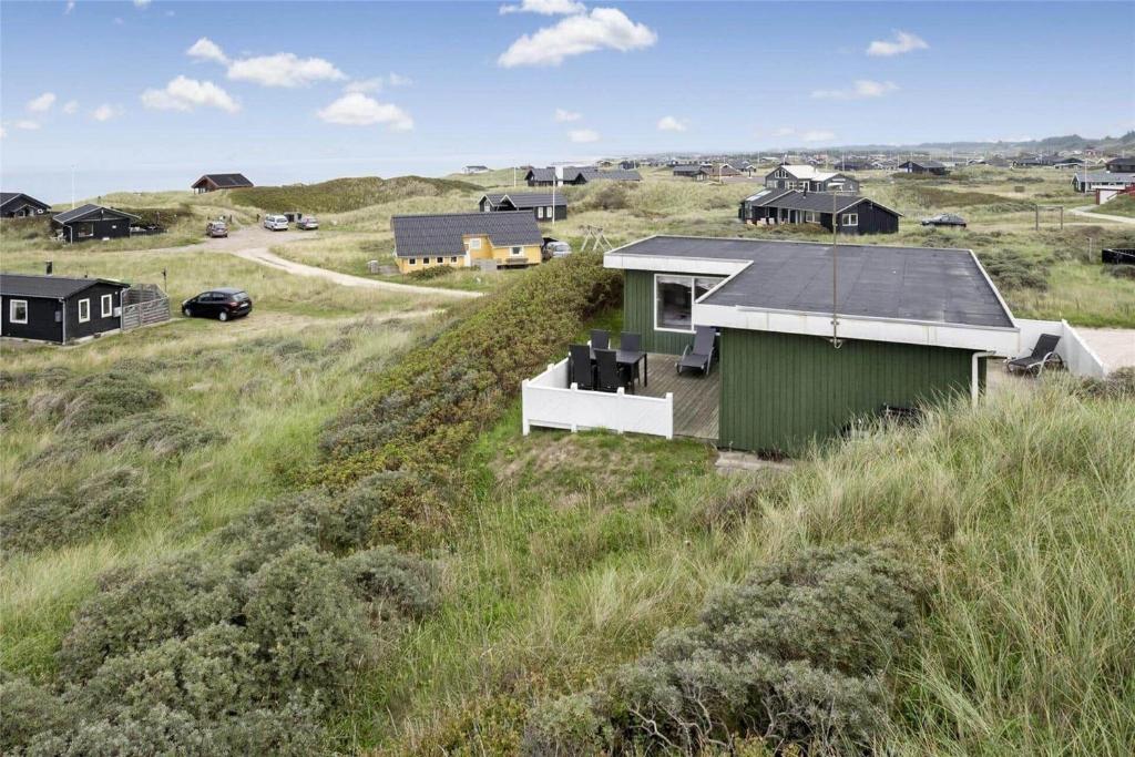 a house on the side of a hill in a field at LN76217-Hjorring-Hjaelmerenden-2 in Hjørring