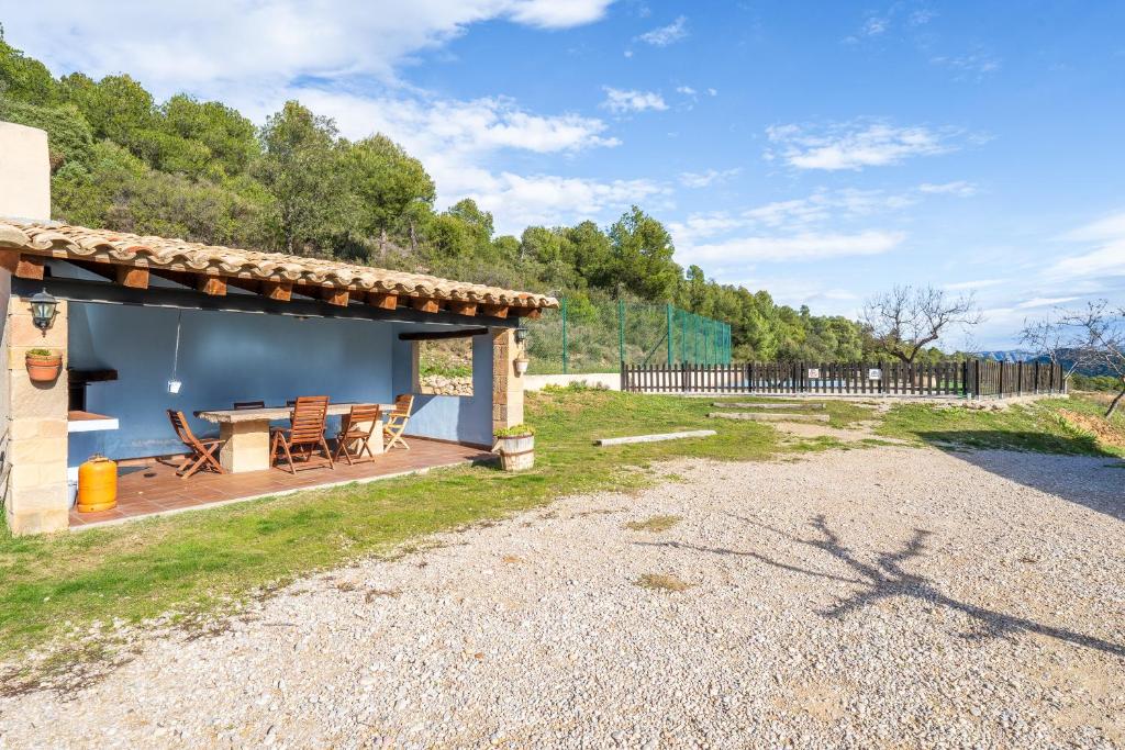 a patio of a house with a table and chairs at La Pallisa in Peñarroya de Tastavins