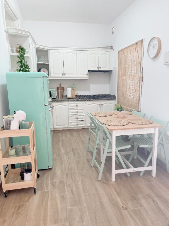 a kitchen with a table and a blue refrigerator at Abades South Beach Domi,air,wifi ,parking in Abades