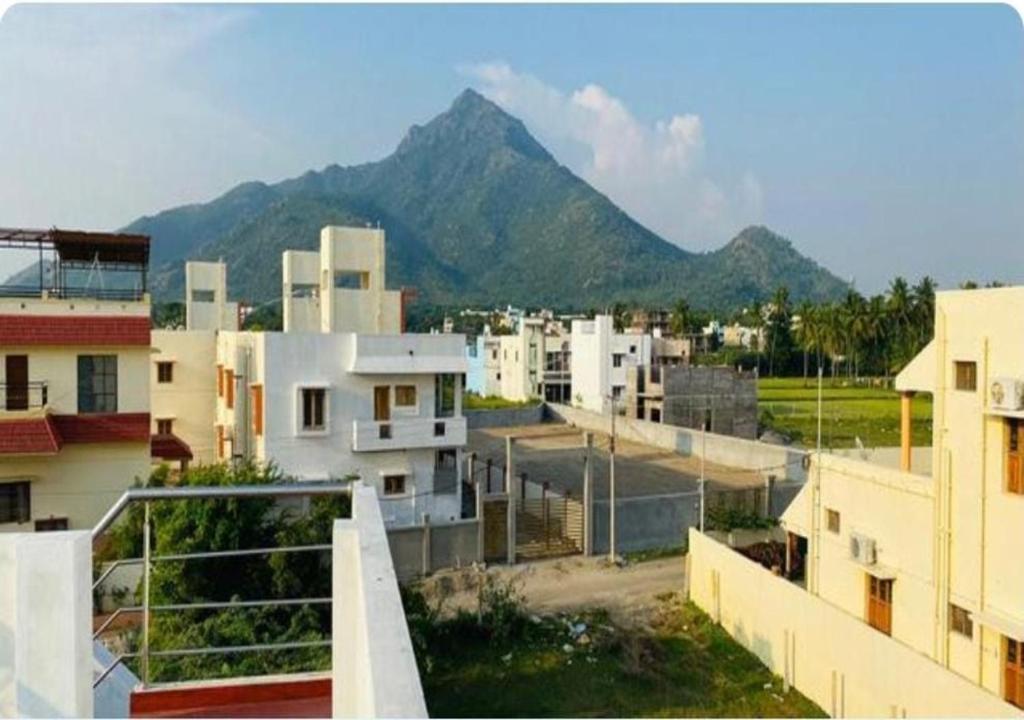 a view of a city with a mountain in the background at Sacred Arunachala View Homestay and Rooms in Tiruvannāmalai
