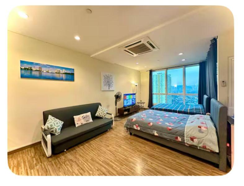 a bedroom with a bed and a couch at Setapak Central Mall Bathtub & Netflix in Kuala Lumpur