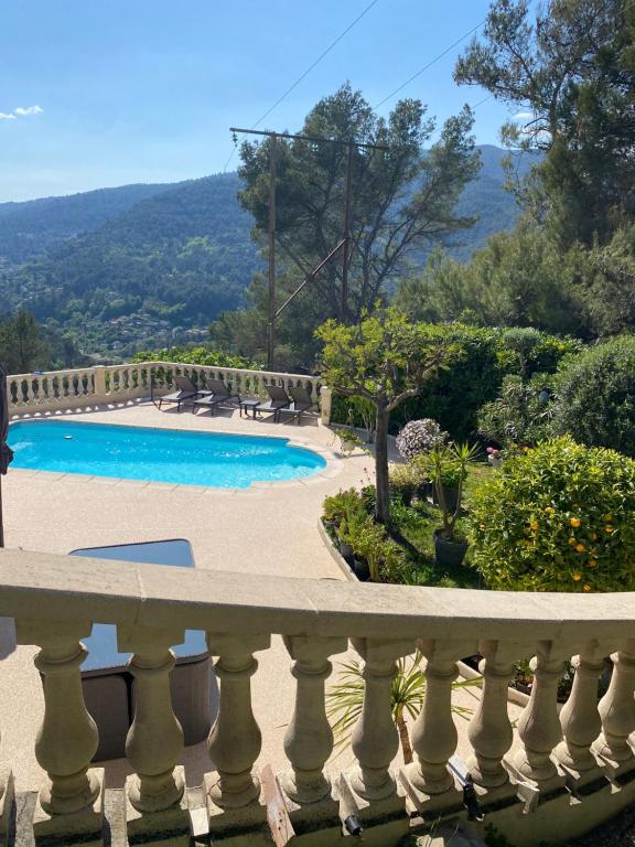 a view of a swimming pool from a balcony at Charmante Villa à 15 min de Nice avec piscine in Blausasc