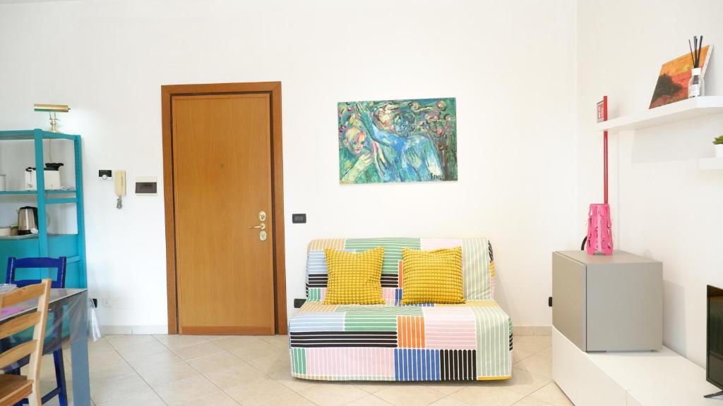 a living room with a couch with yellow pillows at La casa di Betta in zona Torrevecchia-Gemelli in Rome