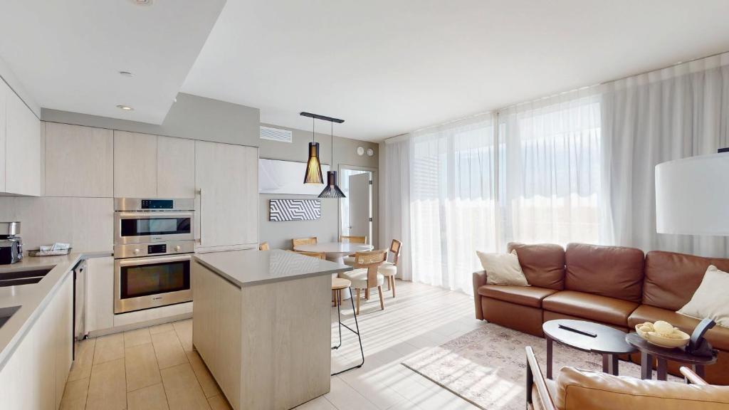 a kitchen and living room with a couch and a table at Hyde Beach House 3BR2BA in Hollywood