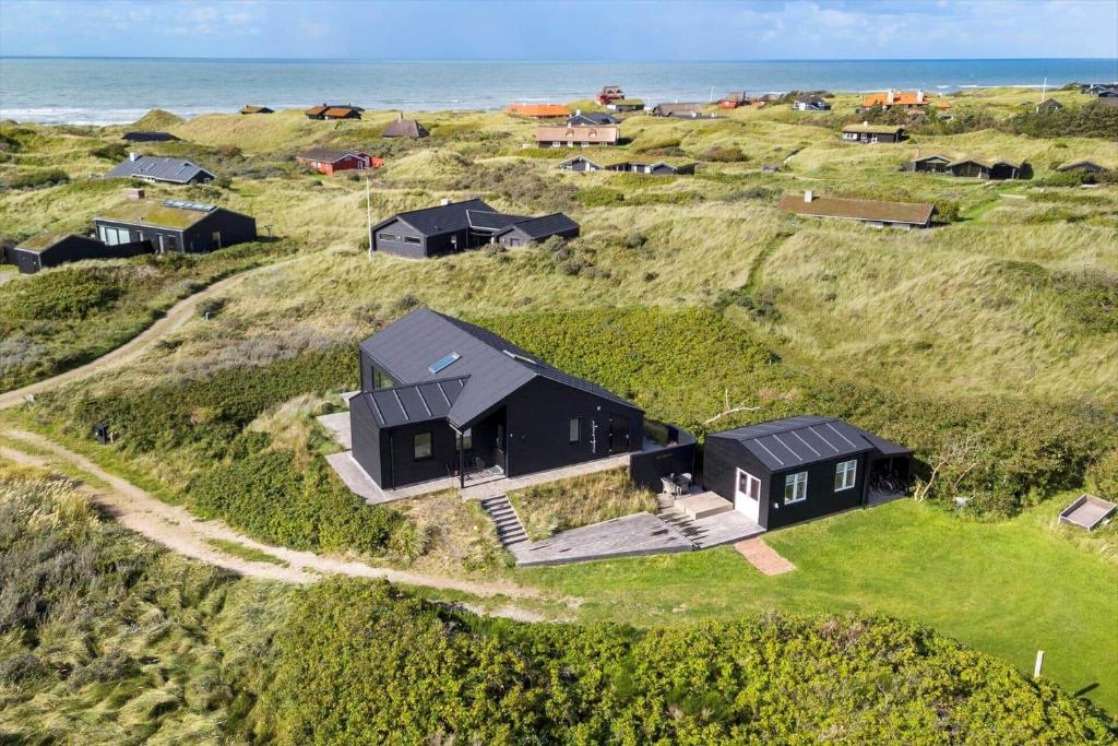an aerial view of a black house on a hill near the ocean at LN1865-Hirtshals-Krageklit-30 in Hirtshals