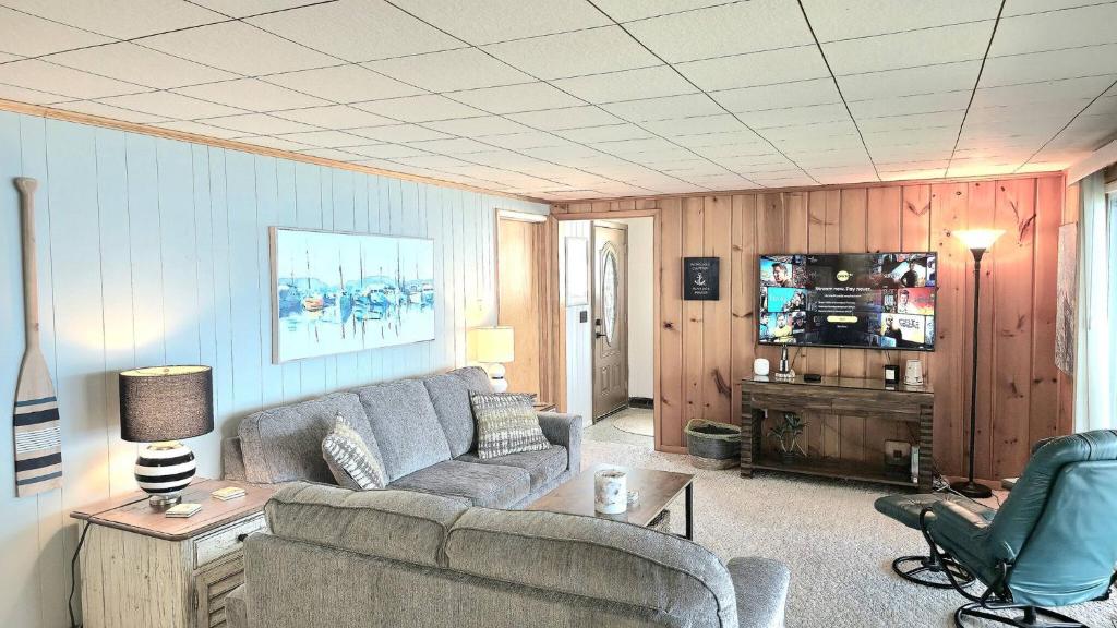 a living room with a couch and a tv at Milton's Cottage in Lake Milton