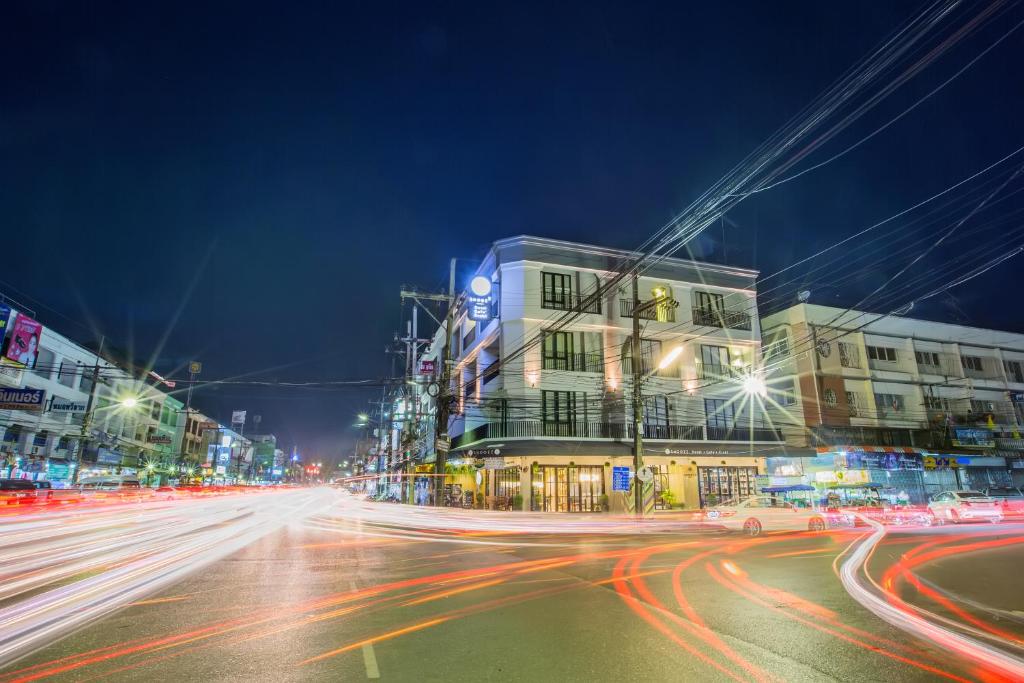 a city street at night with a building and cars at Snoozz Hotel Krabi in Krabi town