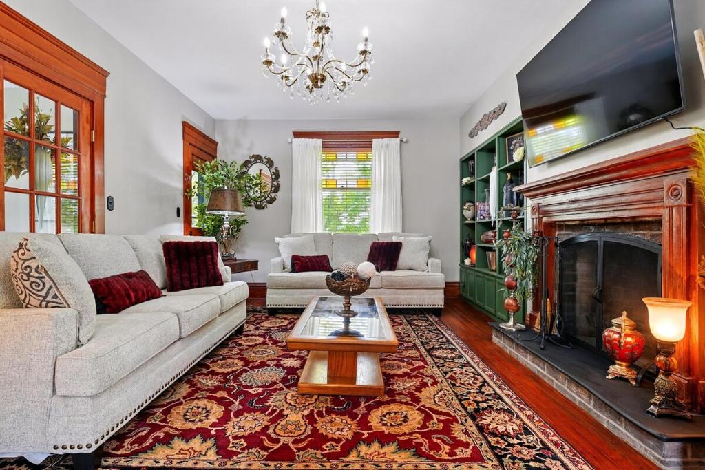 a living room with a couch and a fireplace at The Victorian House in Canfield