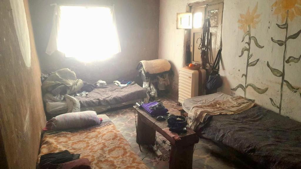 a room with three beds and a window at Tribu 13 Eco Village in Las Escobas