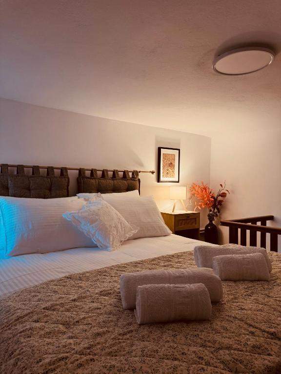 a bedroom with a large bed with two pillows on it at Porta Mesta in Chios