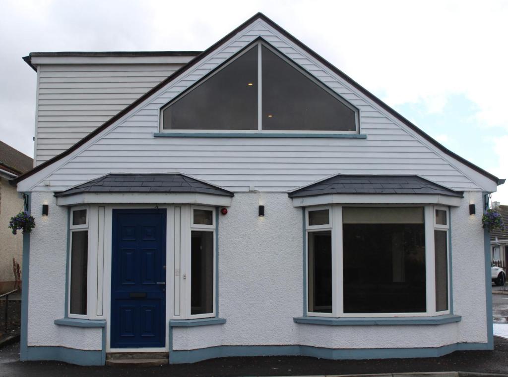 a house with a blue door and a window at The Boutique Bungalow in Bundoran