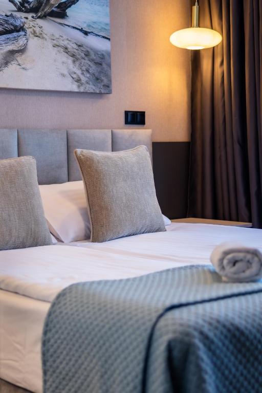 a hotel room with two beds and a lamp at MOTTO Hotel Gdańsk Riverside OLD TOWN in Gdańsk