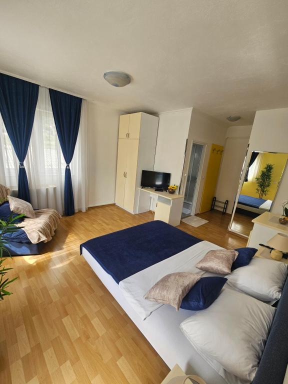Ένα ή περισσότερα κρεβάτια σε δωμάτιο στο Rooms MIG