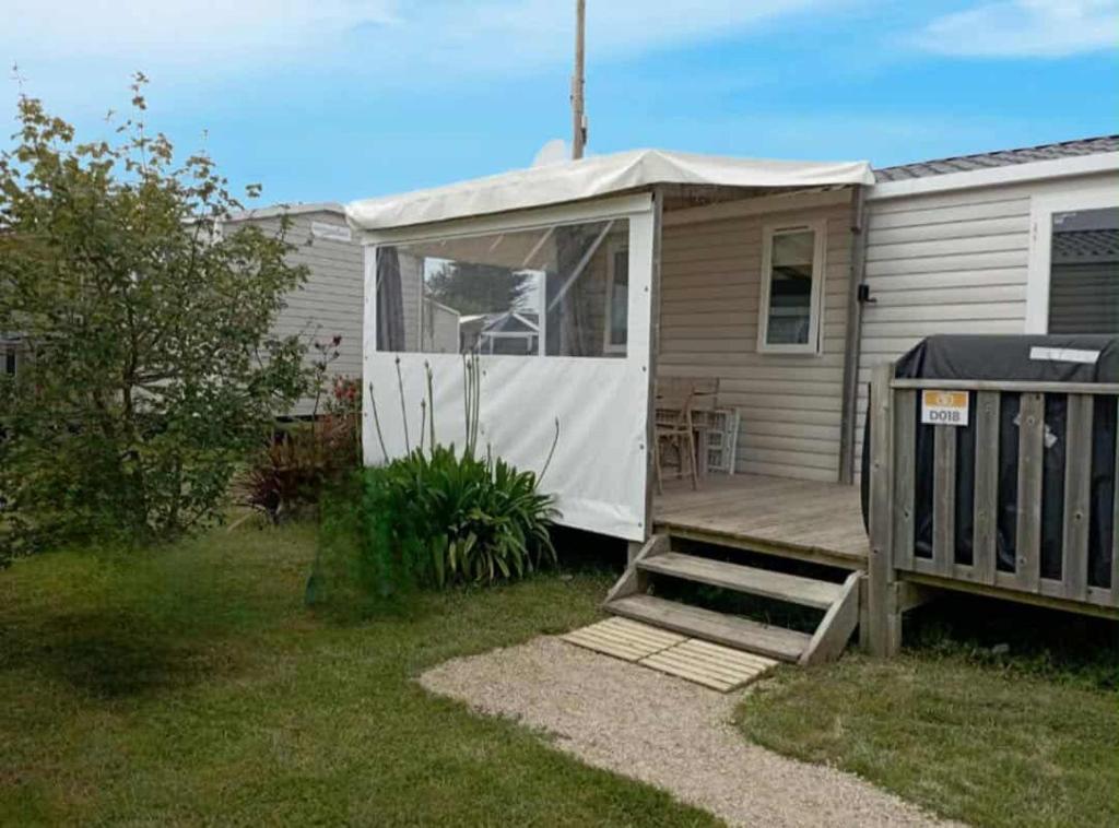 a mobile home with a porch and a deck at mobil-home bord de plage in Sarzeau
