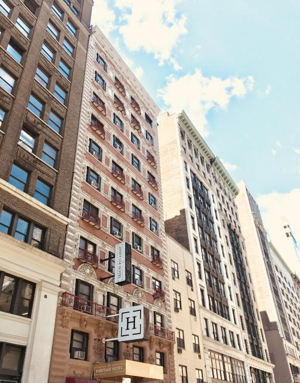 a street sign in front of some tall buildings at Heritage Hotel New York City in New York