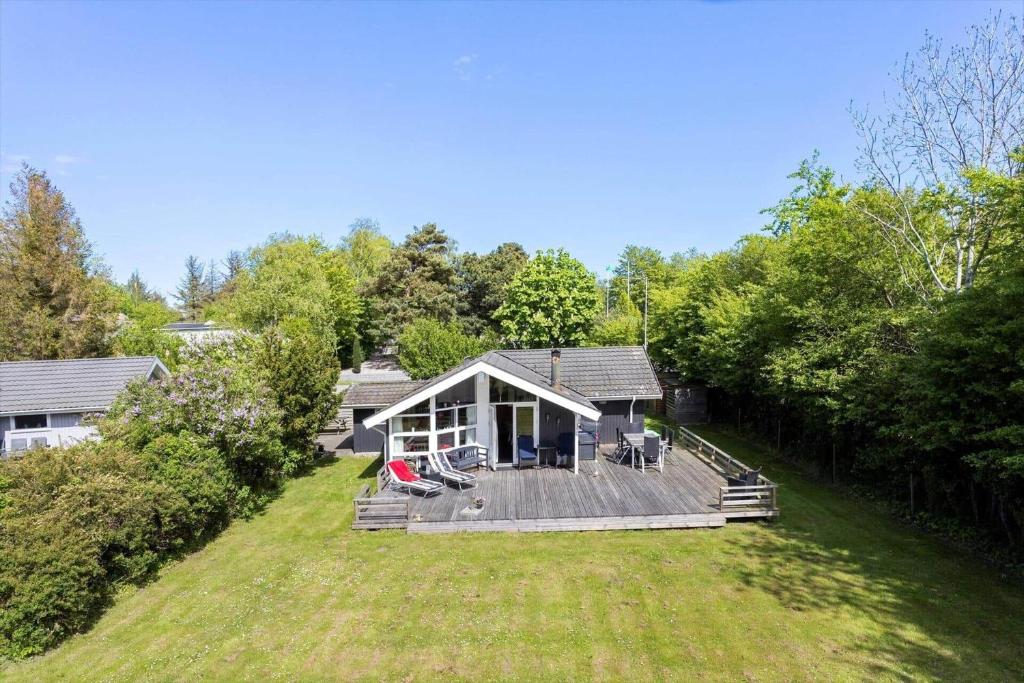 a house with a large deck in a yard at LL209-Humble-Ristingevej-141-A in Humble