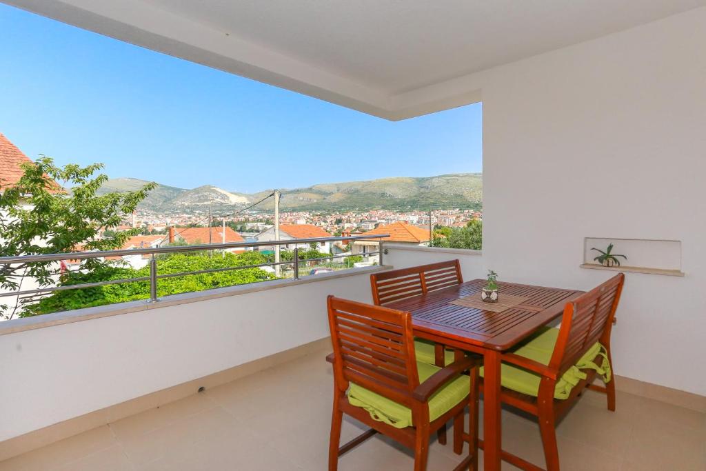 comedor con mesa y sillas y balcón en Apartments Ivan en Trogir