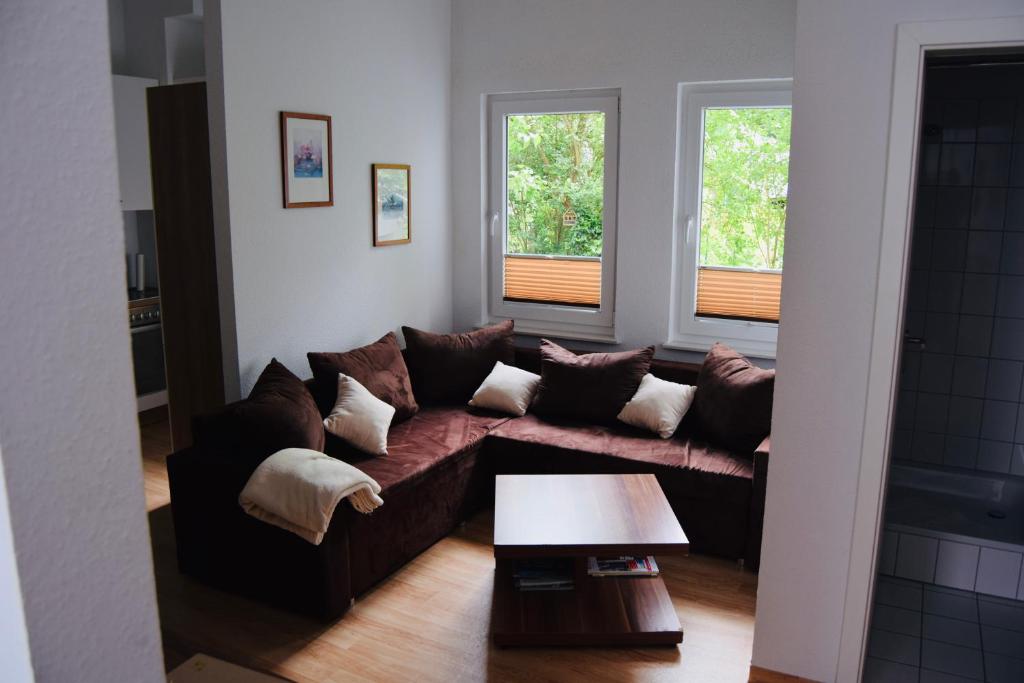 a living room with a couch and two windows at Ferienappartment in der City in Bremen